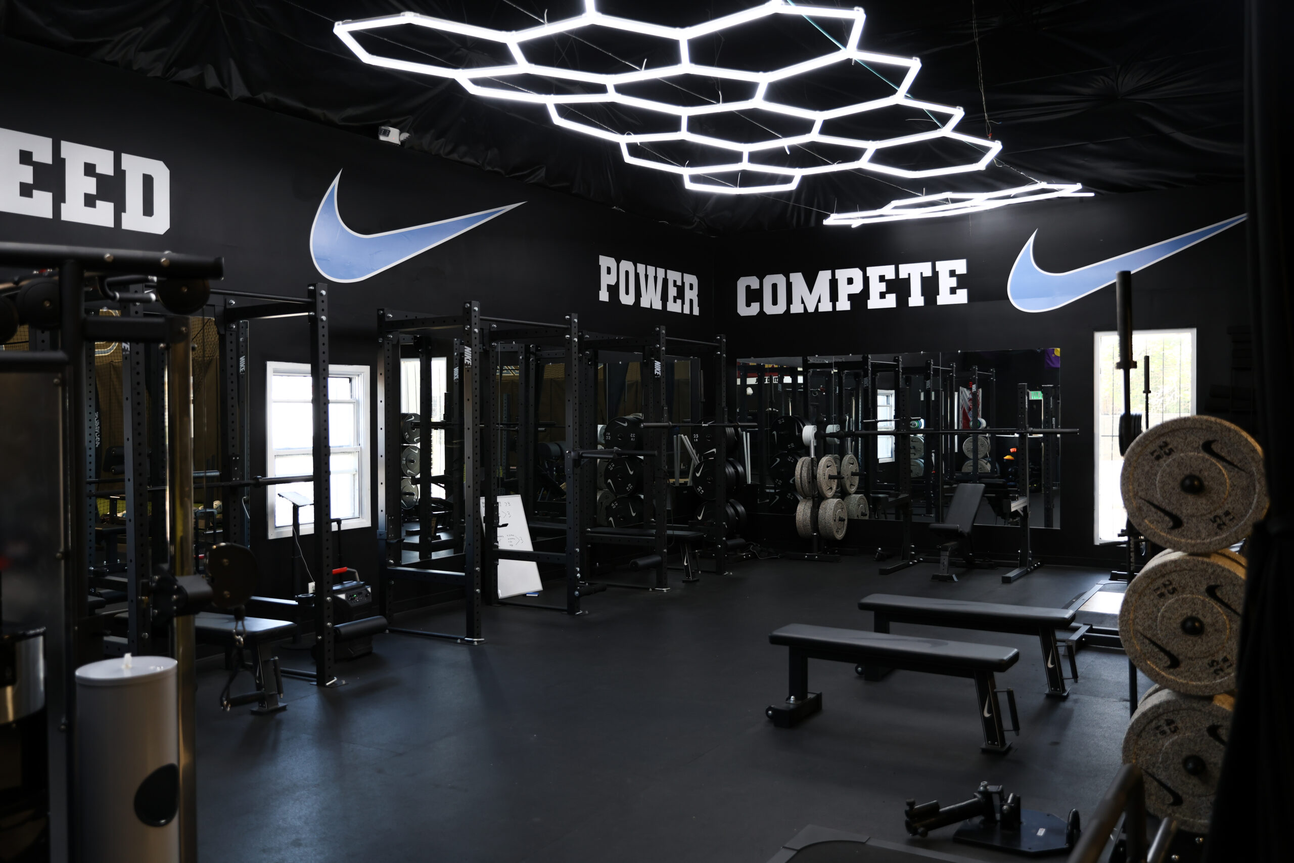 Concourse K main weight room with Nike racks and hexagon lighting